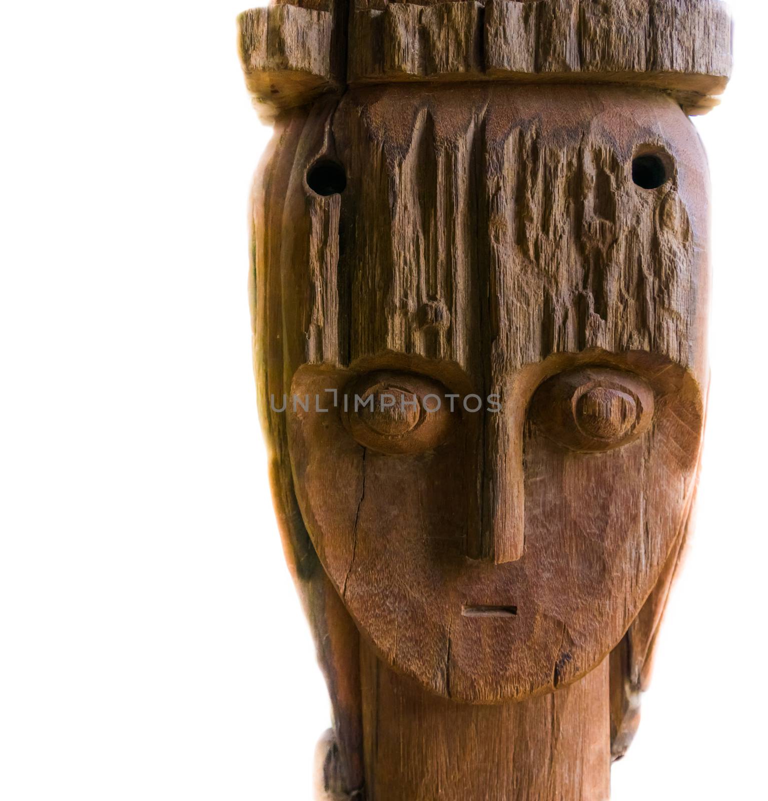 the face of a African carved wooden statue in closeup, isolated on a white background, Traditional and cultural decorations
