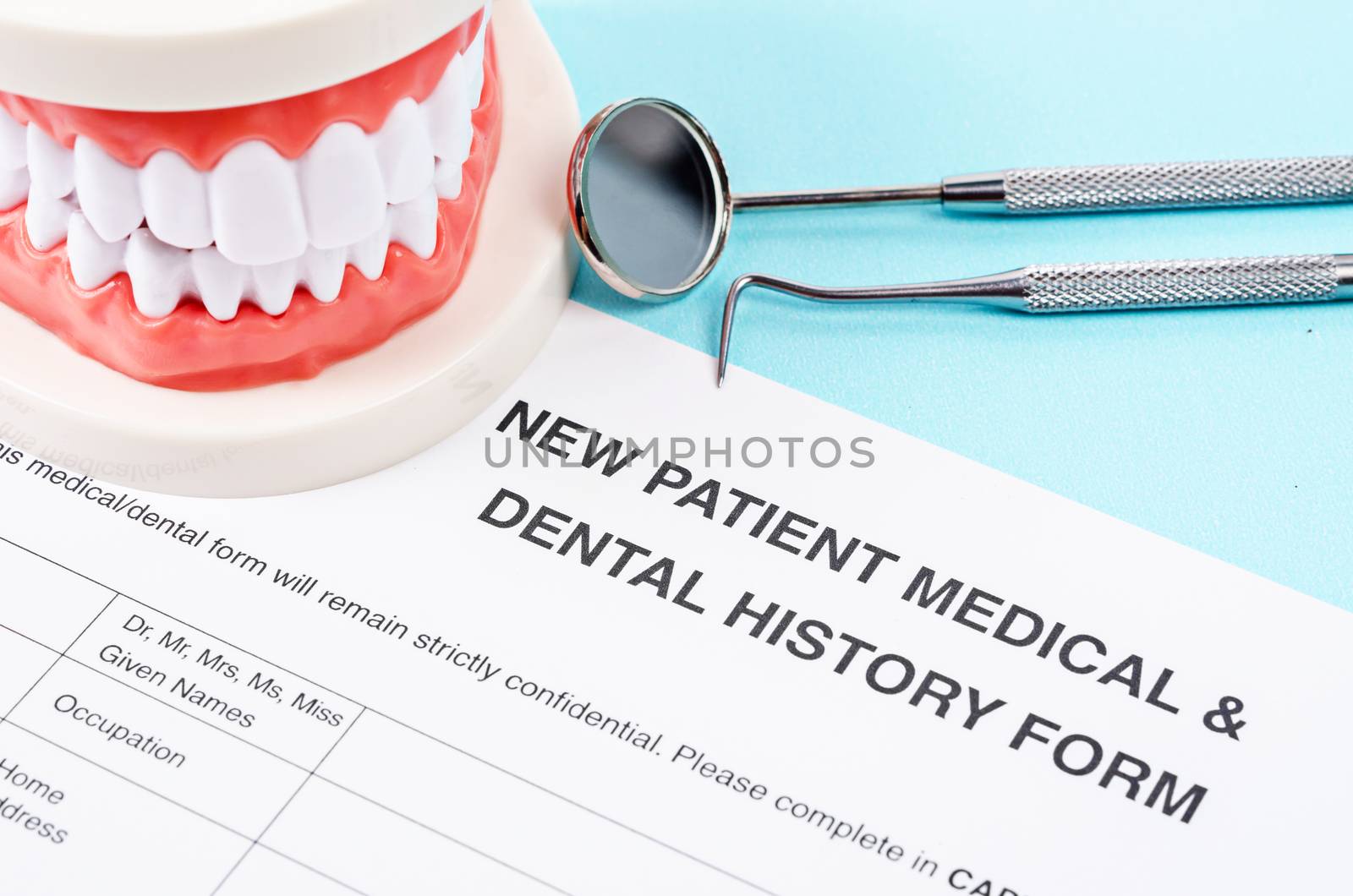 Dental history form with model tooth and dental instruments. Dental health and teeth care concept.