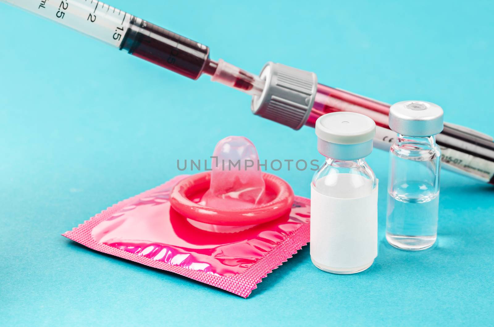 Condom and vaccine bottle with sample blood. by Gamjai