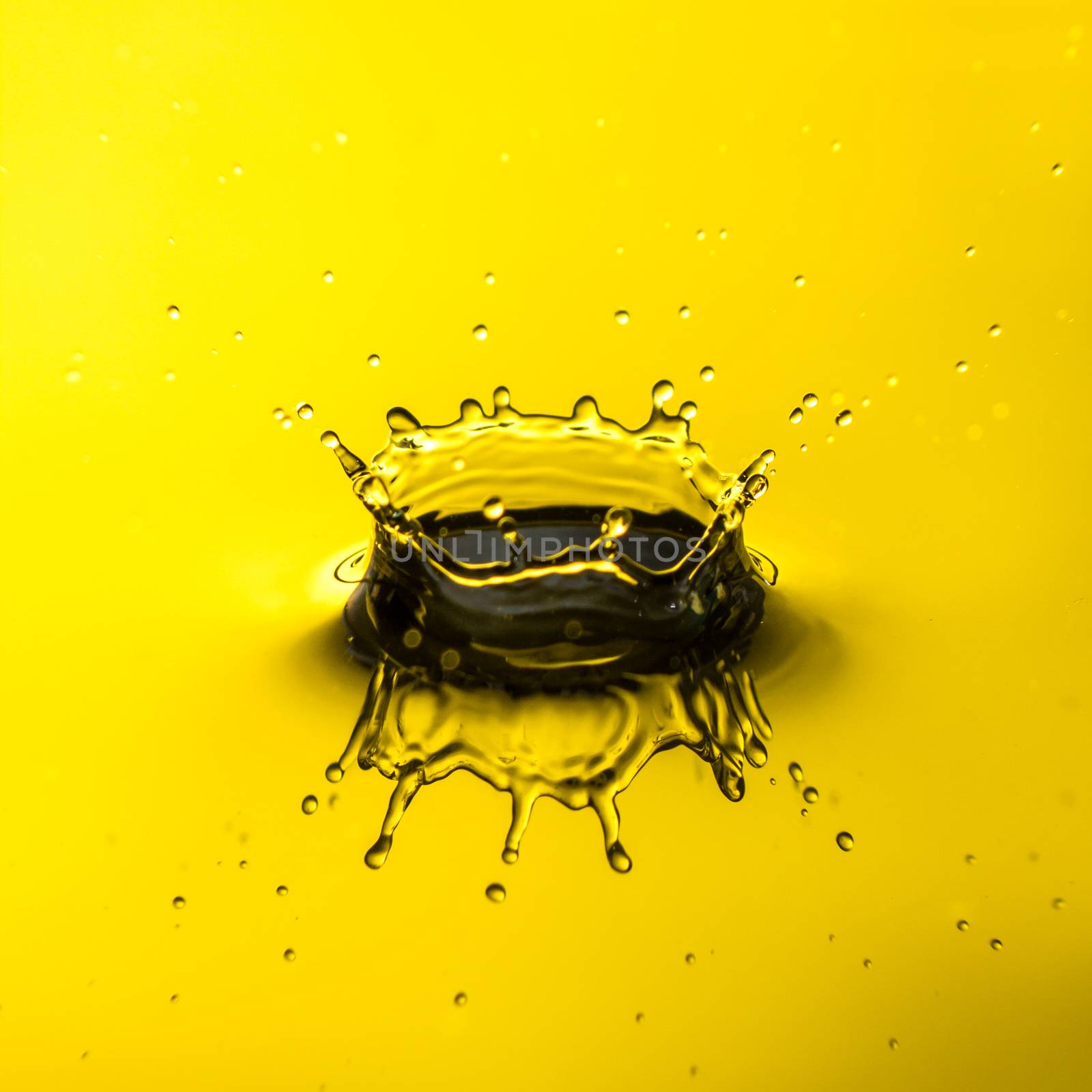 Close up of water droplet or splash-Image, yellow backgroung by petrsvoboda91