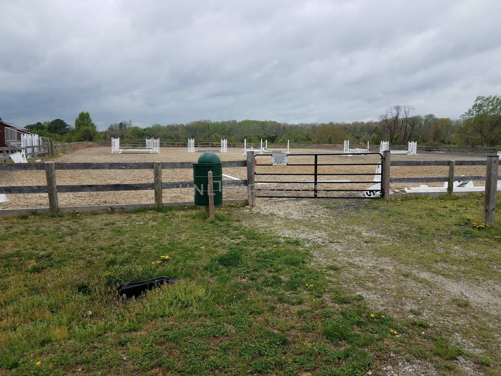 metal gate or door and garbage can at equestrian arena