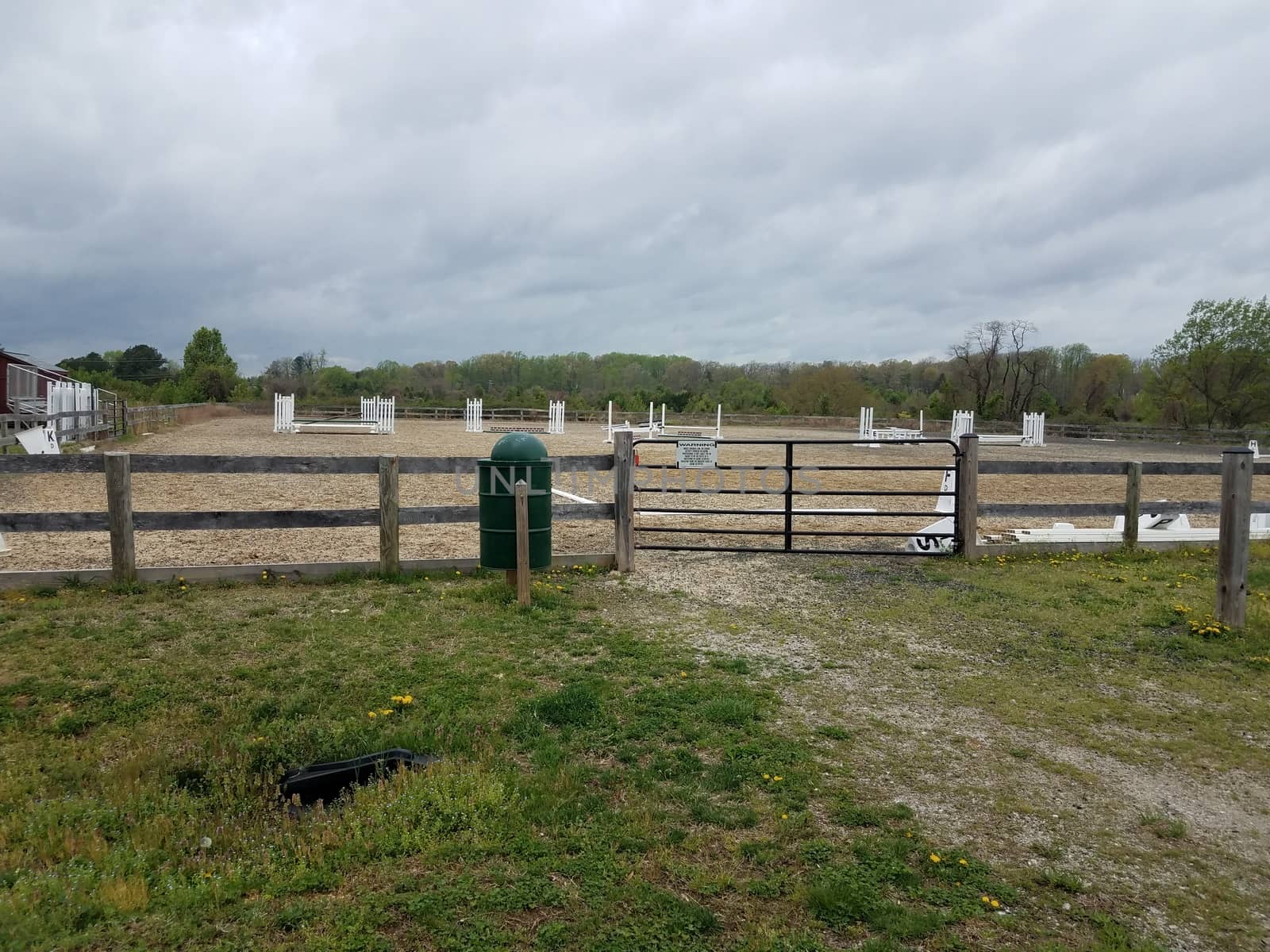 metal gate or door and garbage can at equestrian arena