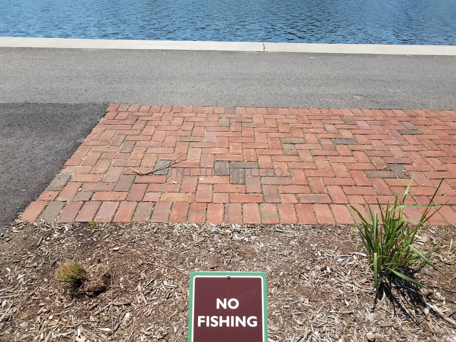 no fishing sign with red bricks and water by stockphotofan1