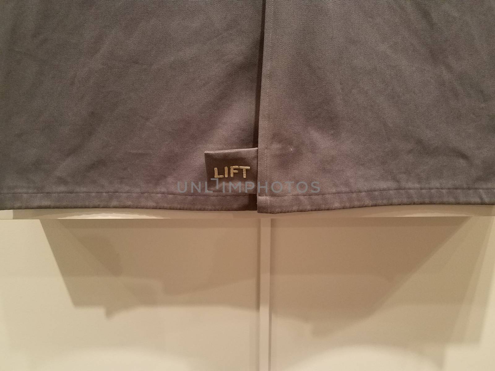 lift or lifting sign on blue or grey fabric on wall