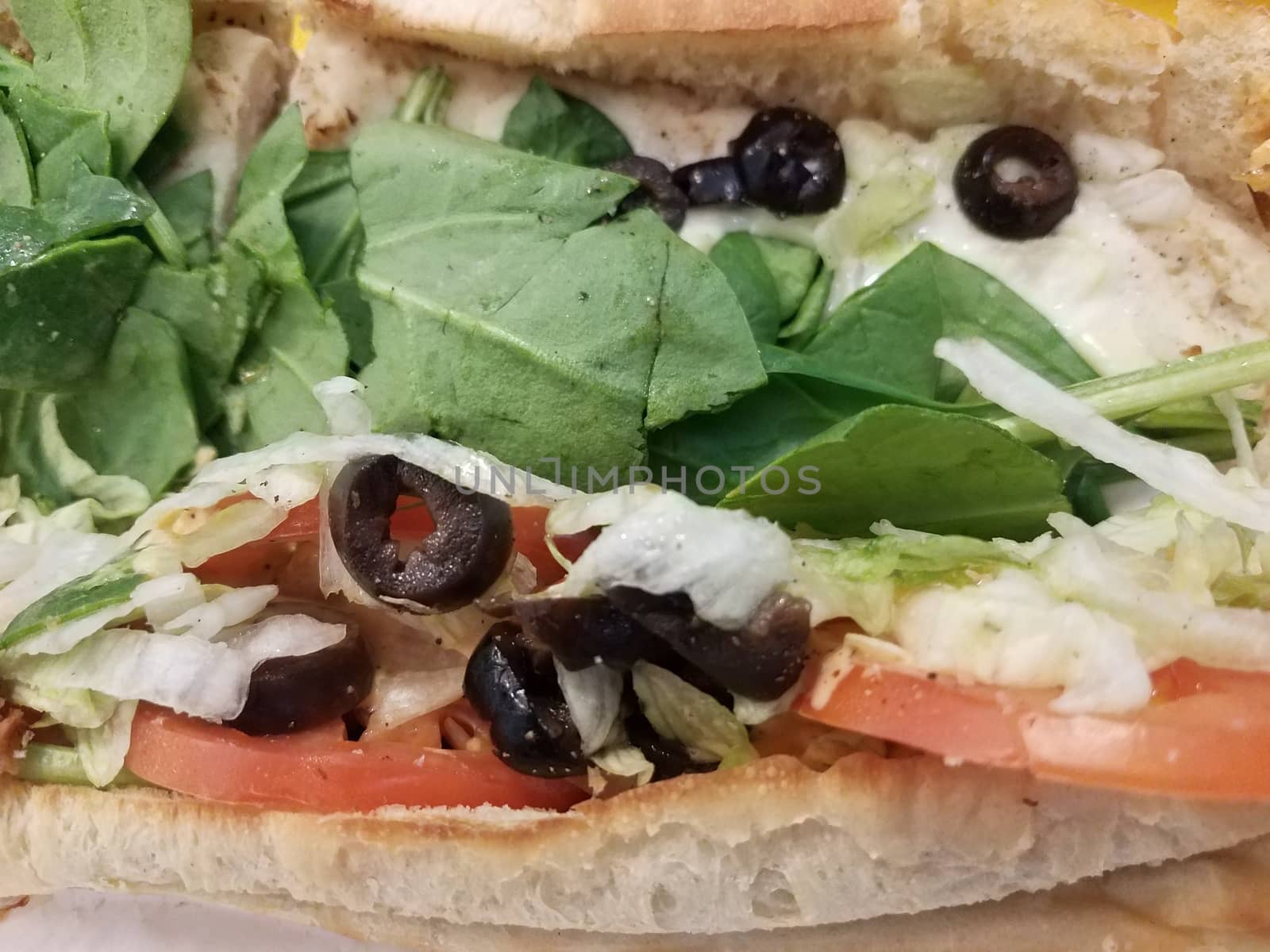 sandwich with olives, tomato, spinach, and lettuce by stockphotofan1