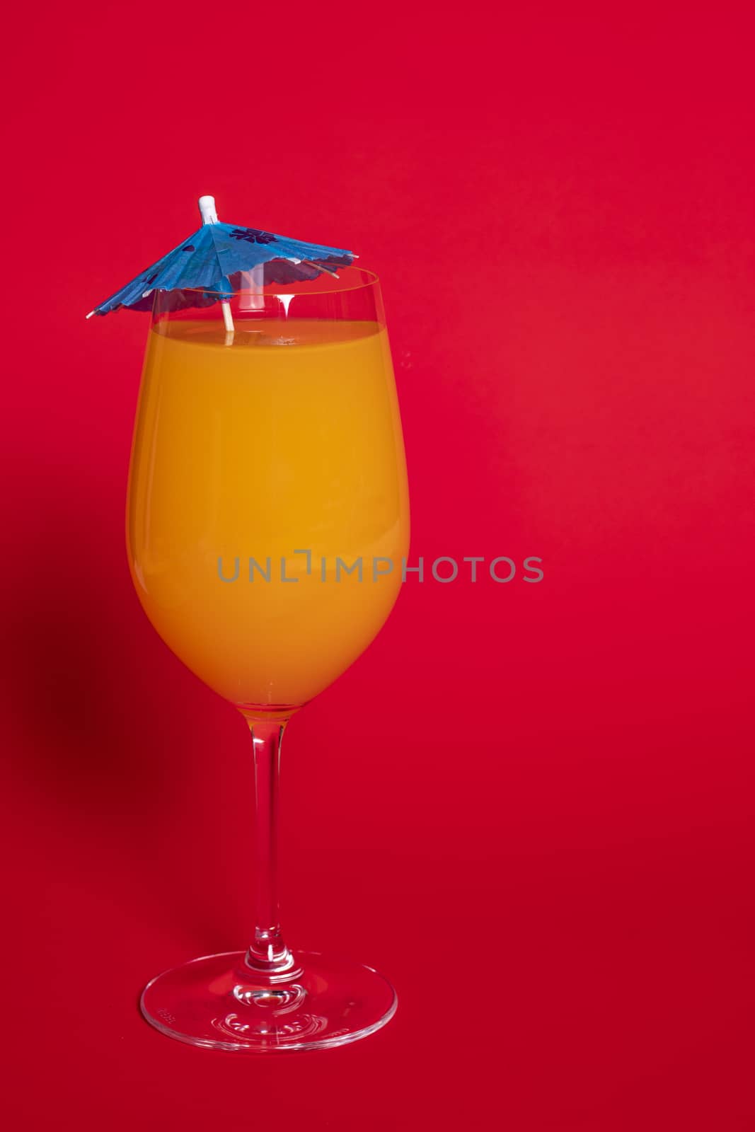 Orange Drink in Wine Glass Against Red I by CharlieFloyd