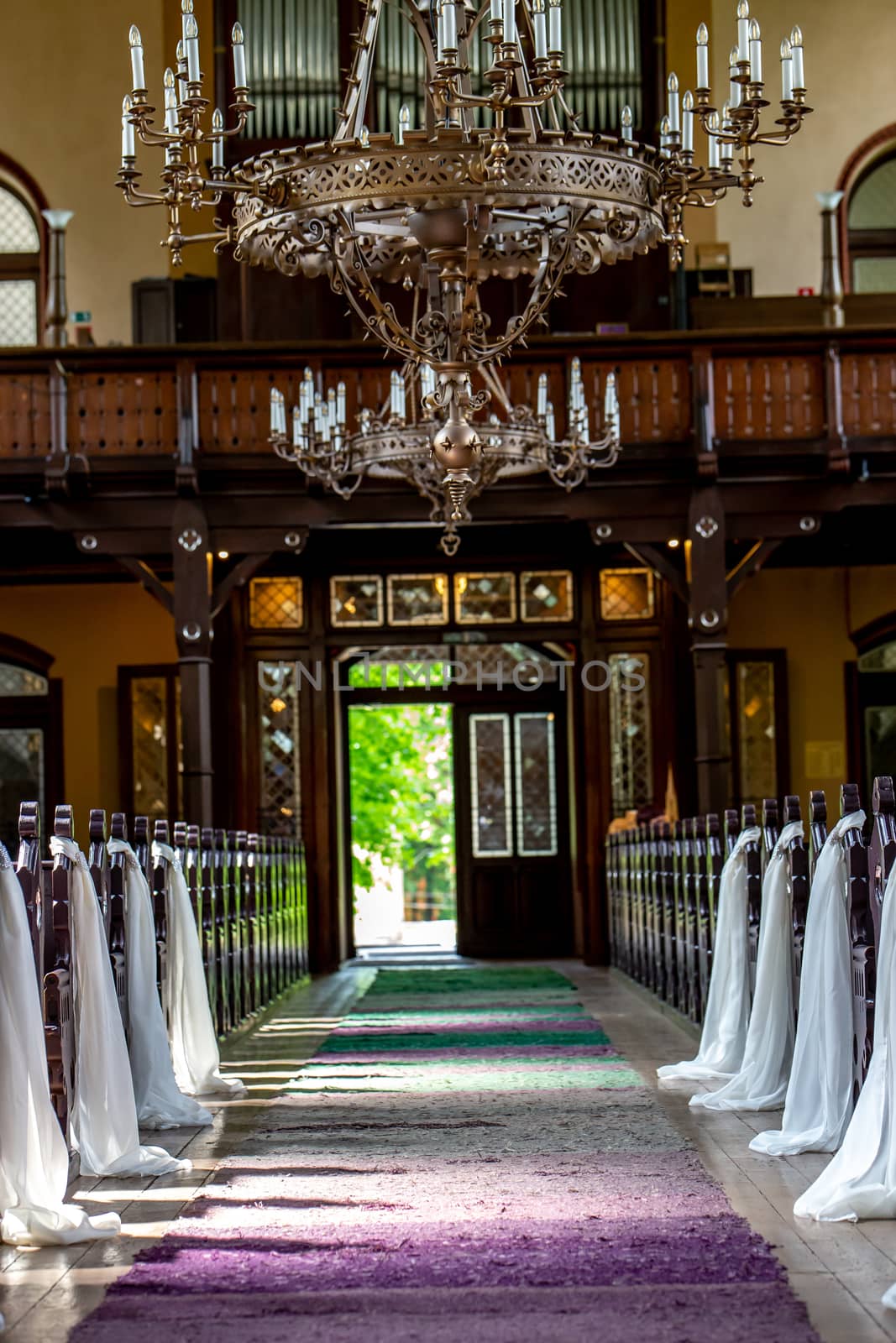 Riga, Latvia - May 18, 2018. Riga Luther Church. White ribbons wedding decoration in the church. Church decorated with white ribbons for wedding marriage ceremony. Church interior before wedding ceremony.