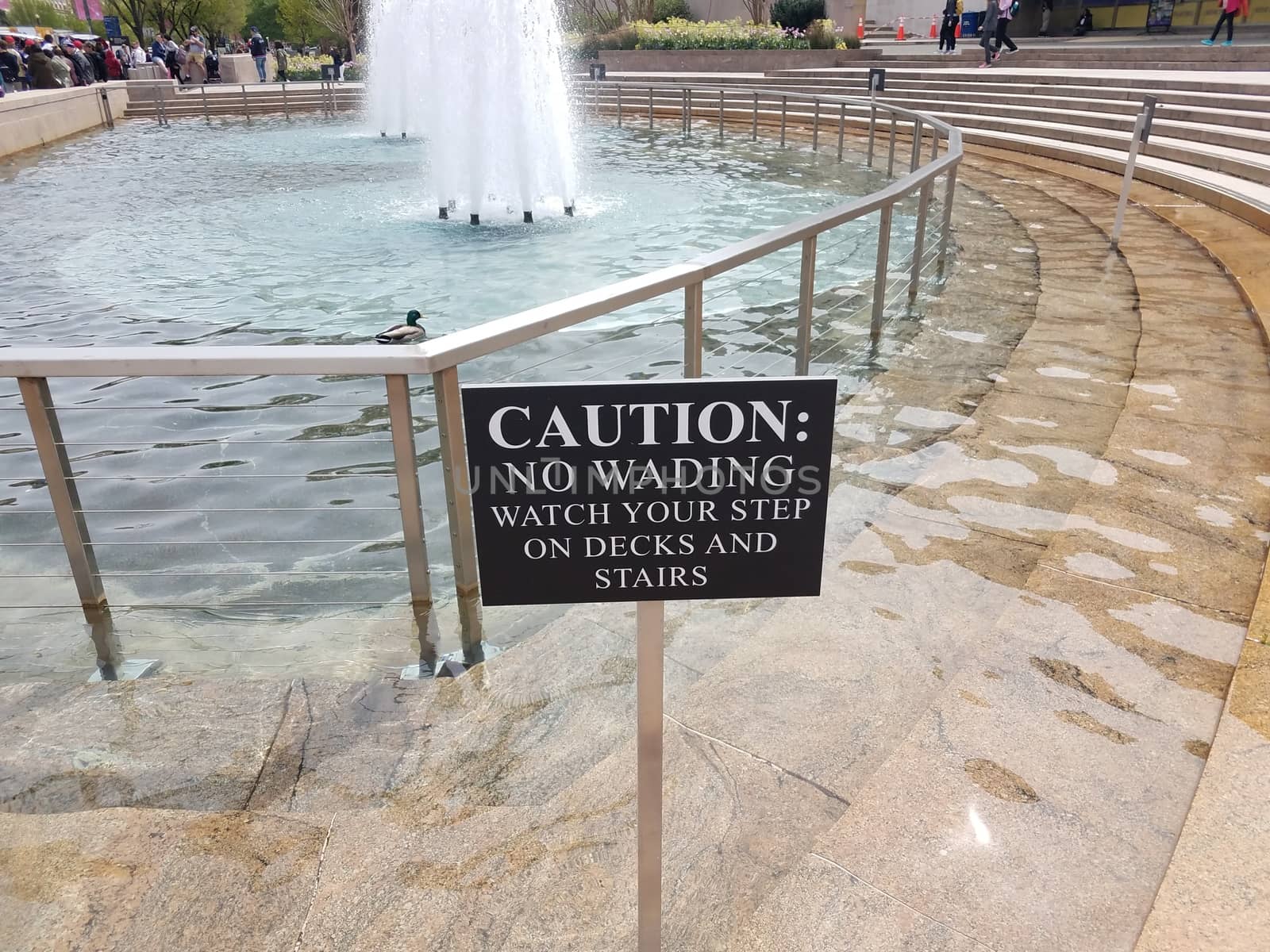 caution no wading watch your step sign with water fountain