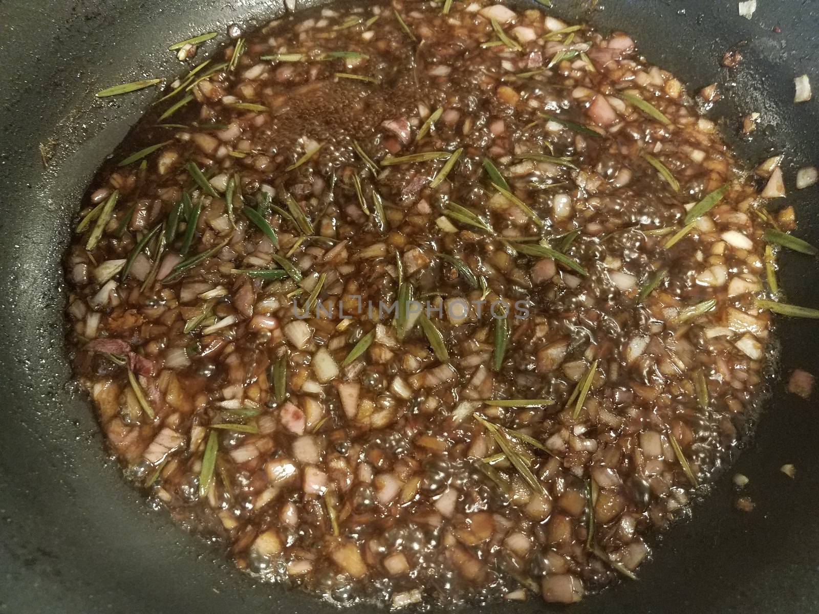 sweet brown fig and rosemary sauce cooking in frying pan or skillet