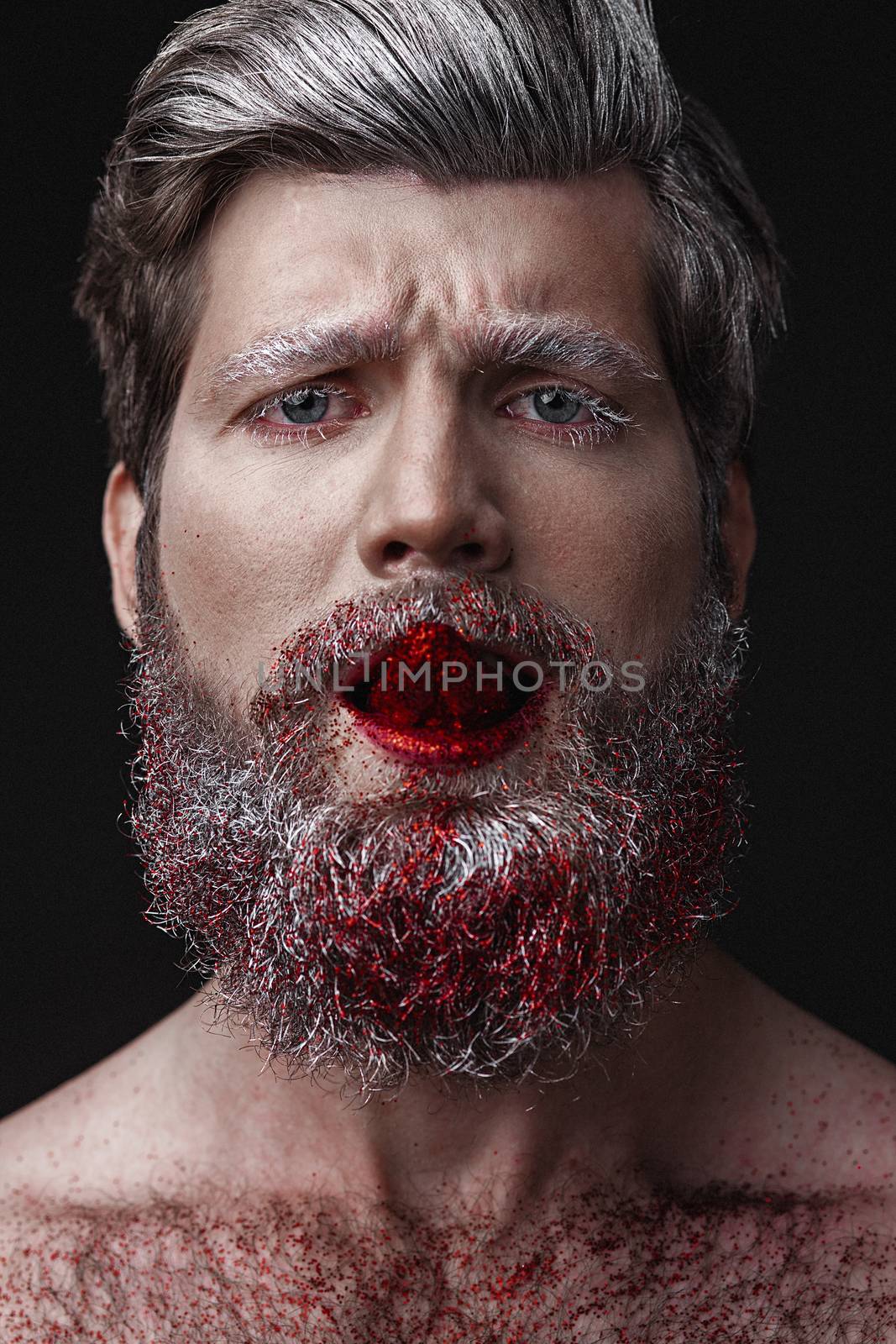 Creative Portrait of grey-haired fashionable man with red lips and tongue