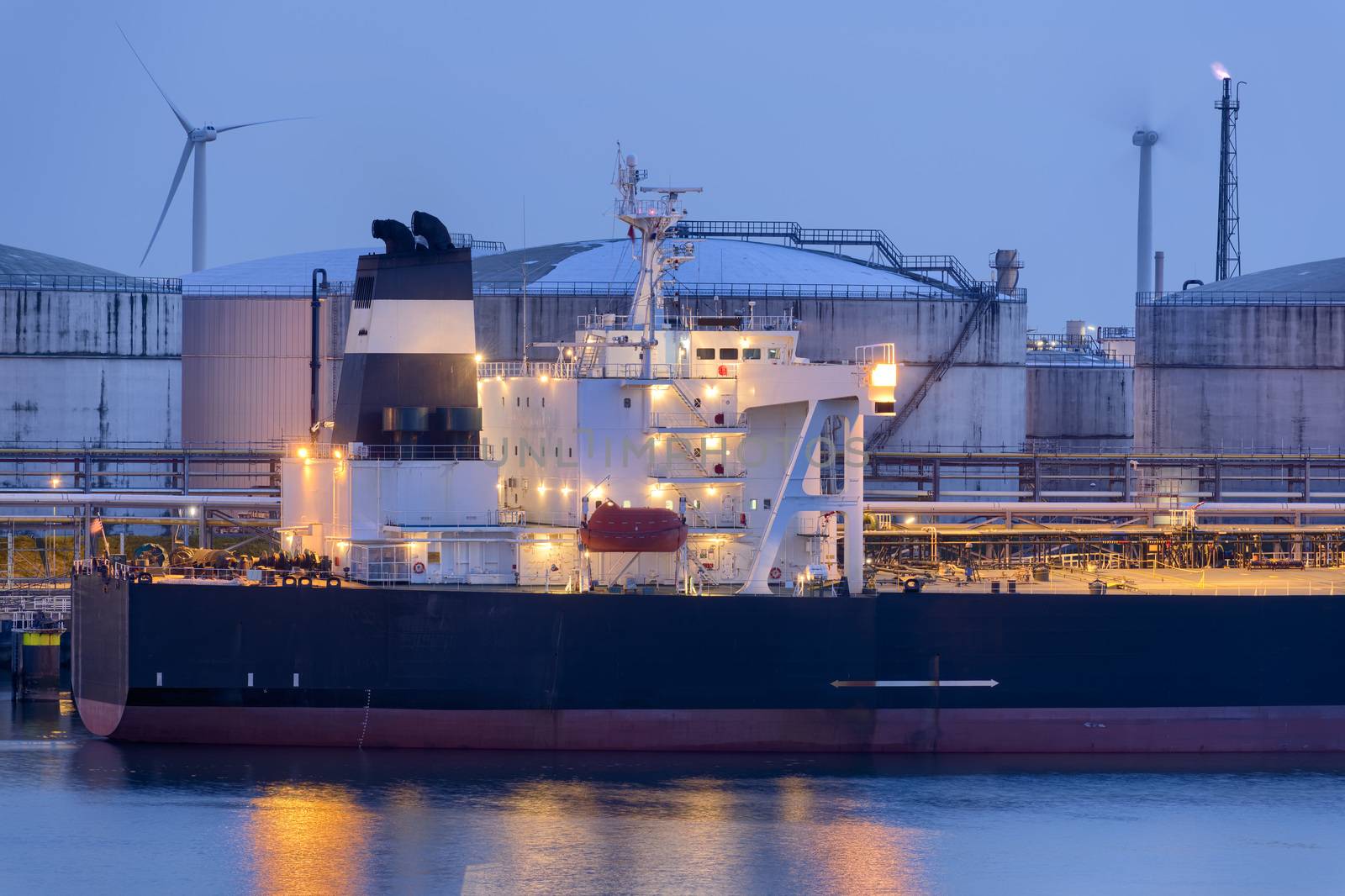 Liquid Natural Gas storage tanks and tanker at dusk, Port of Rotterdam