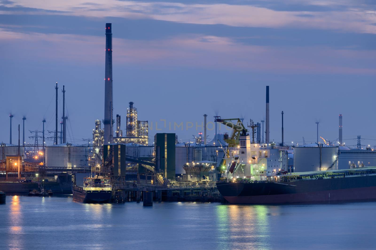 Liquid Natural Gas storage tanks and tanker at dusk, Port of Rotterdam