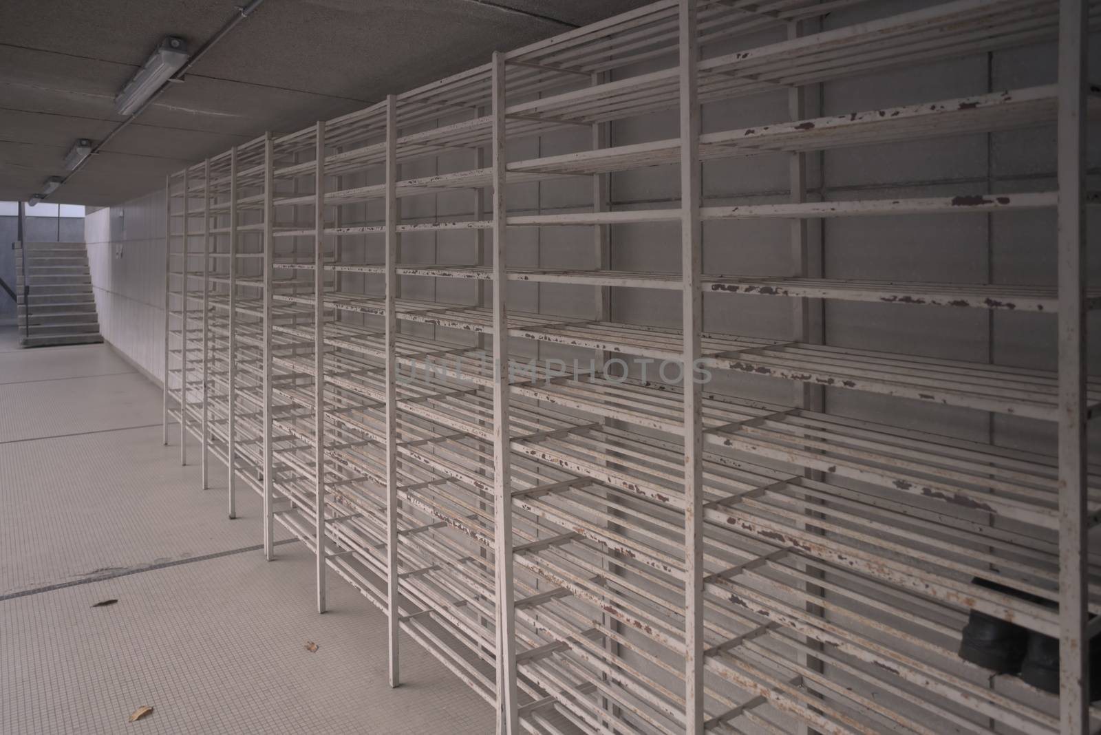empty white metal bars shoes rack storage at the mosque taken from the side