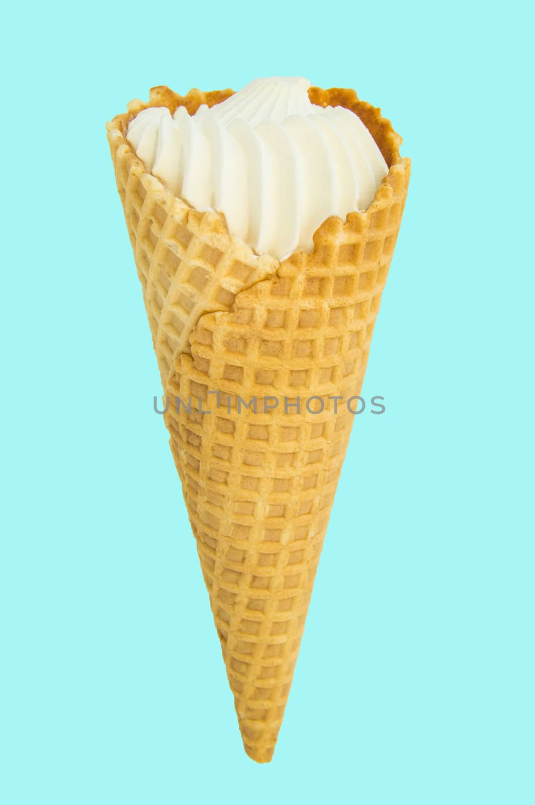 Vanilla ice cream in waffle conVanilla ice cream in waffle cone isolated on pastel blue background, vertical close-up framend,