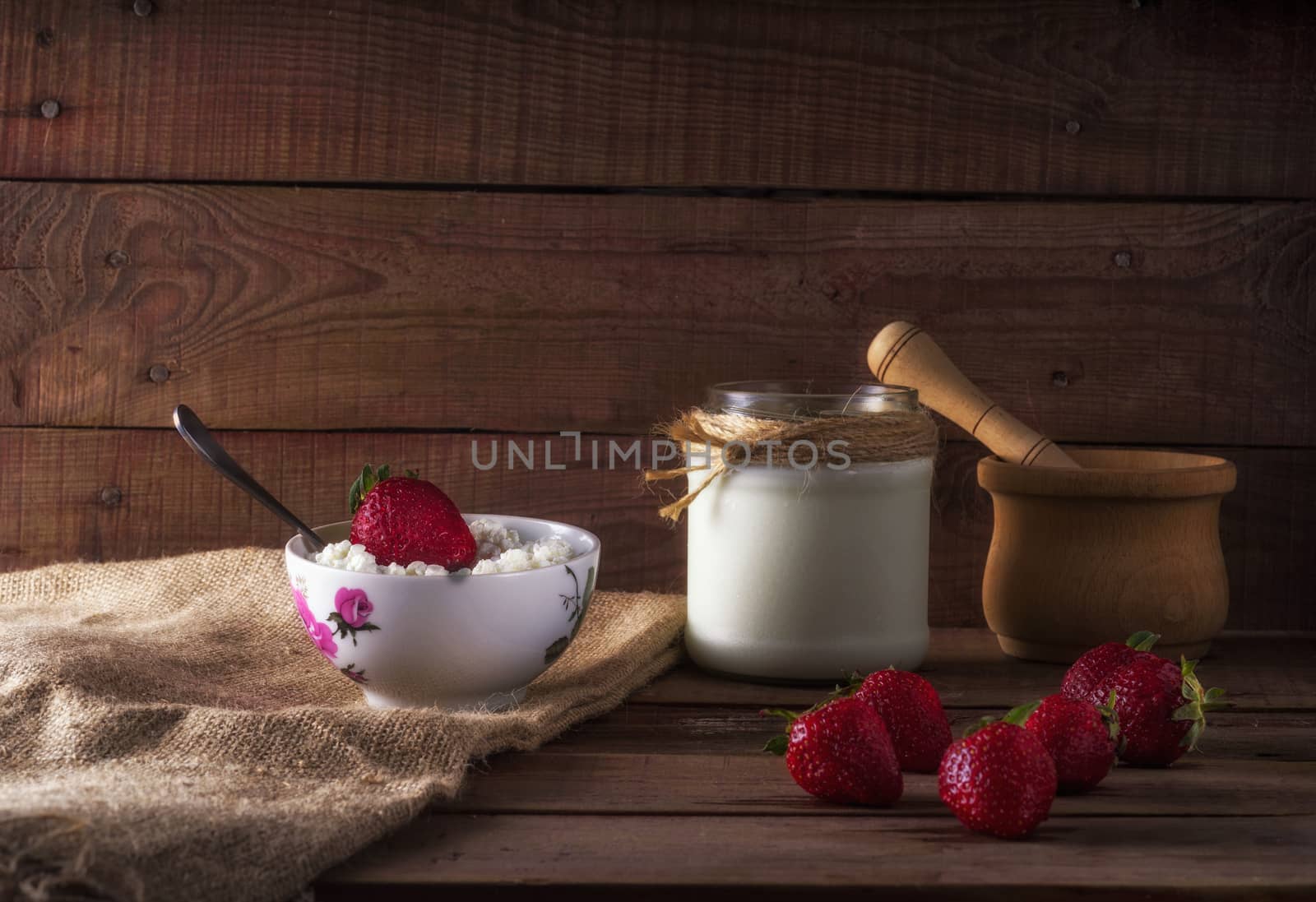 Tvorog, farmers cheese, curd cheese or cottage cheese in bowl with fresh strawberry. by dmitry_derenyuk