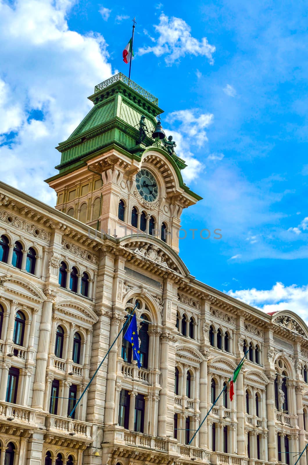 Municipio clock tower building of Trieste in Piazza Unita Italia Italy vertical landmark background .