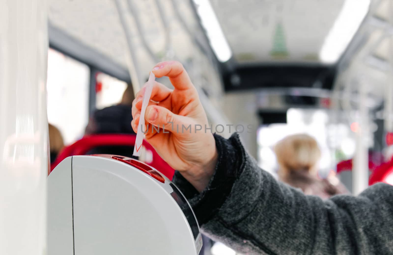 bus ticket insert in validator hand background