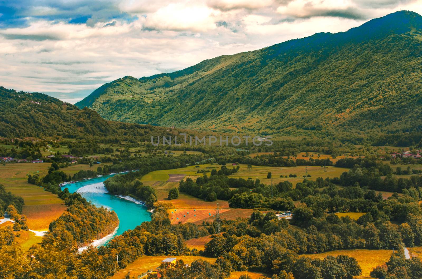 Isonzo Soca river valley  yellow teal and orange sunset landscape in  Slovenia - Italy border .