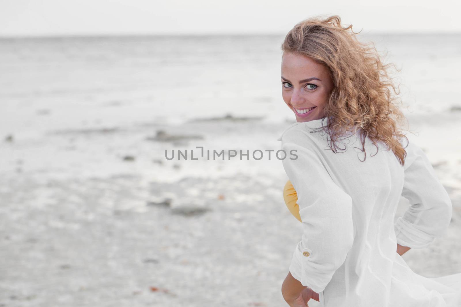 Woman in white shirt refreshing at the ocean, Thailand