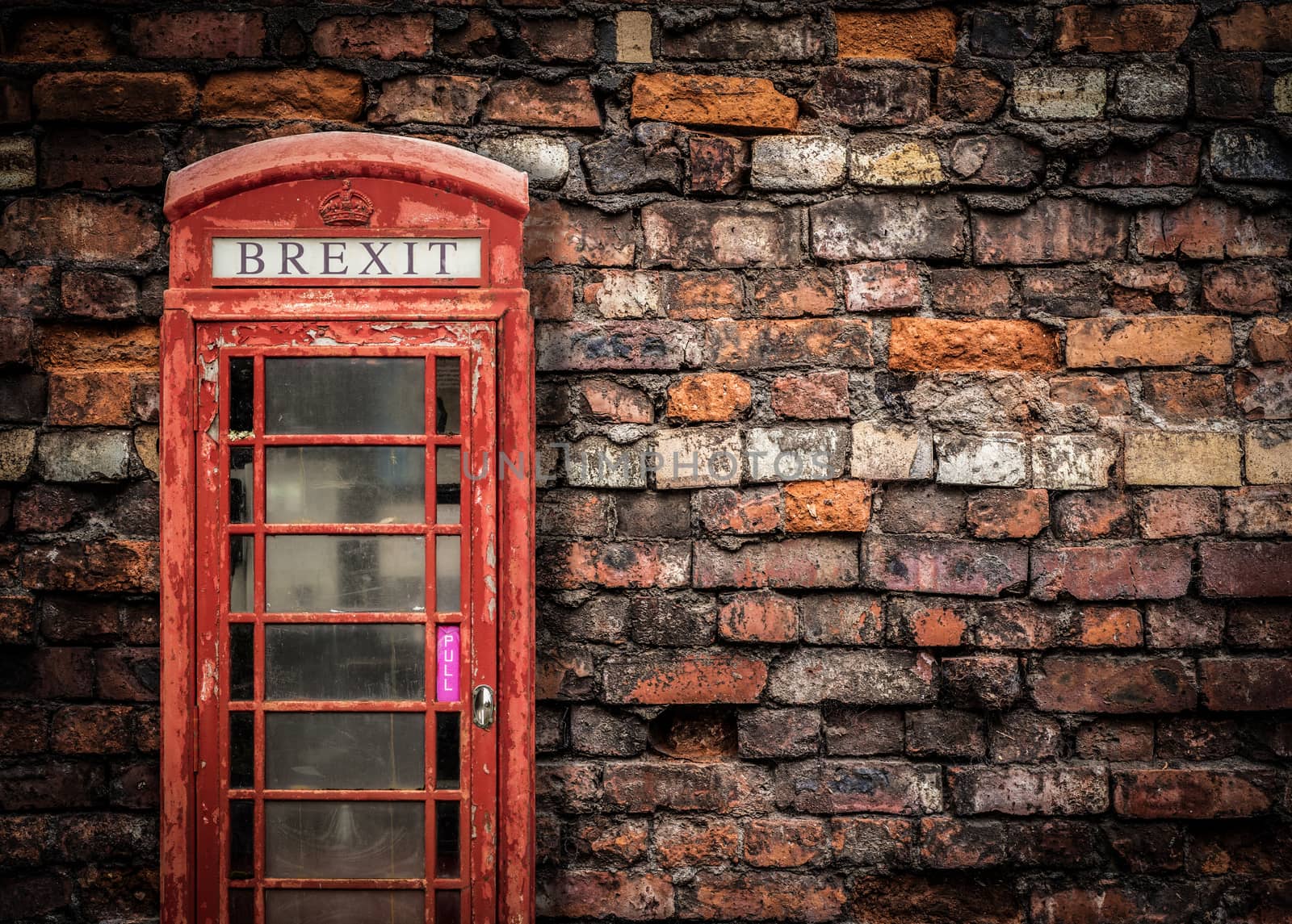 Image Representing Broken Brexit Britain Of An Old Peeling Red Telephone Box Against A Grungy Red Brick Wall With Copy Space