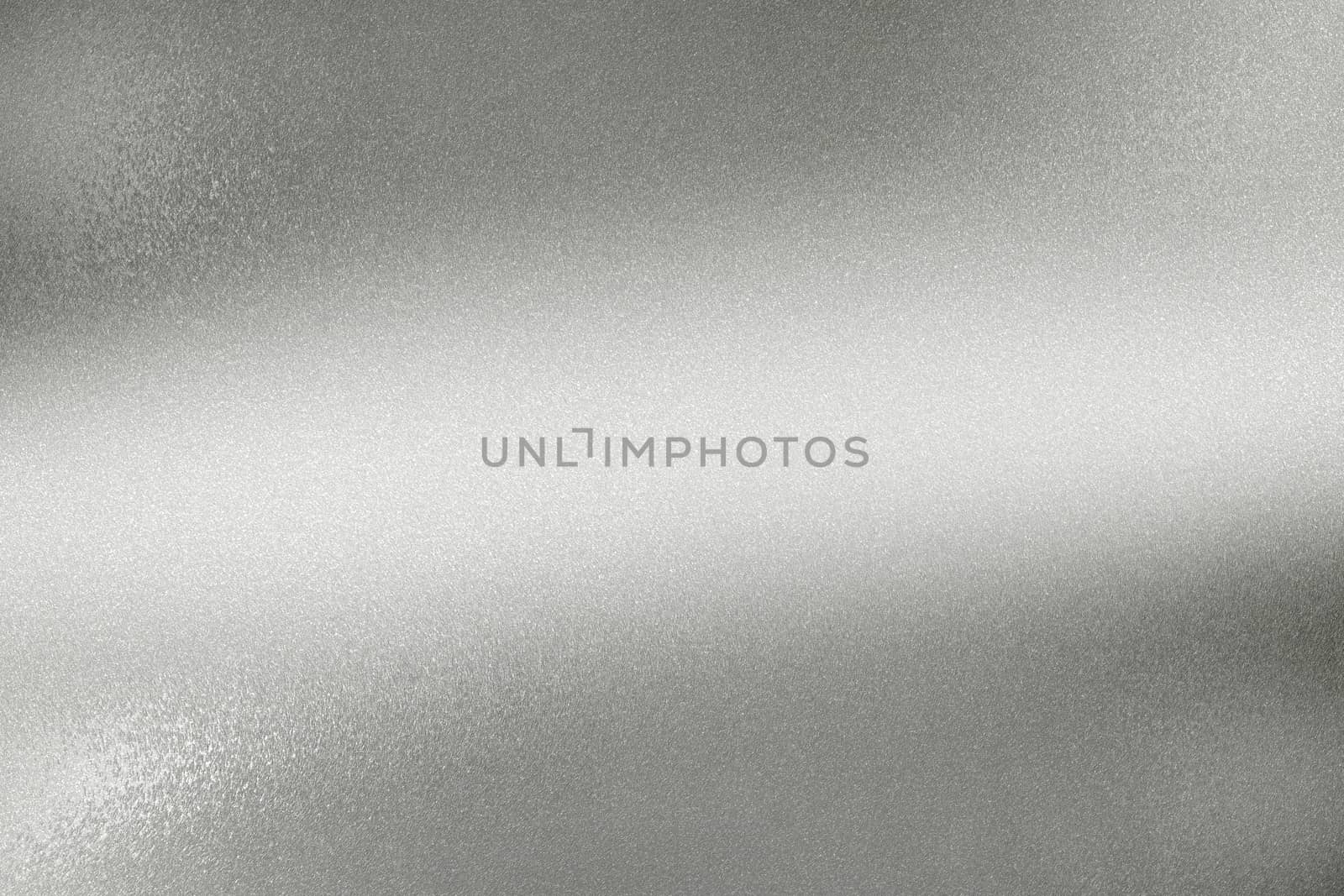 Glowing polished silver wave metal wall, abstract texture background
