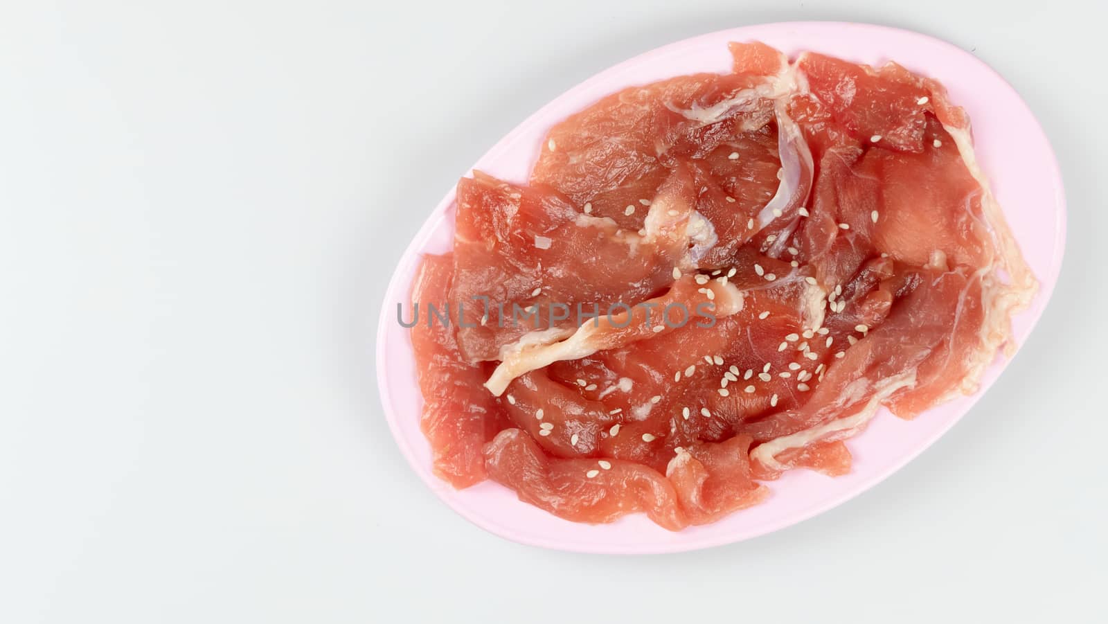 top view raw pork on plate  over white background