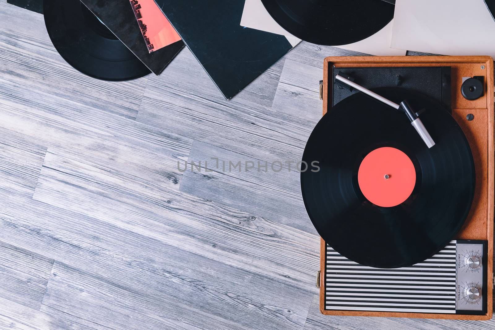 Gramophone vinyl record player on the background of their gray wooden boards. Needle on a vinyl record. Black vinyl record,Sound technology for DJ to mix & play music.