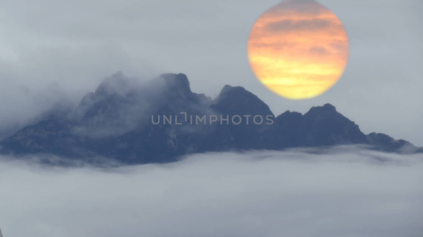 An abstract design for a background of a huge sun setting behind the himalayan mountains