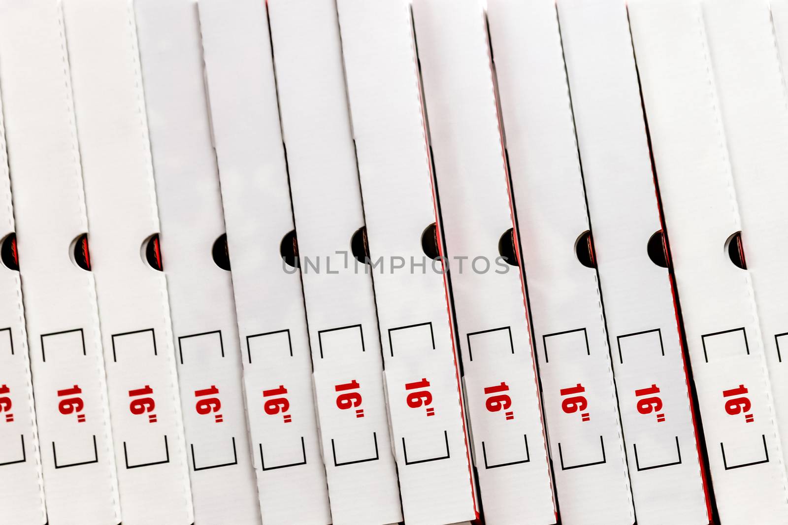 A large stack of white pizza boxes with red numbers diaimeter 16