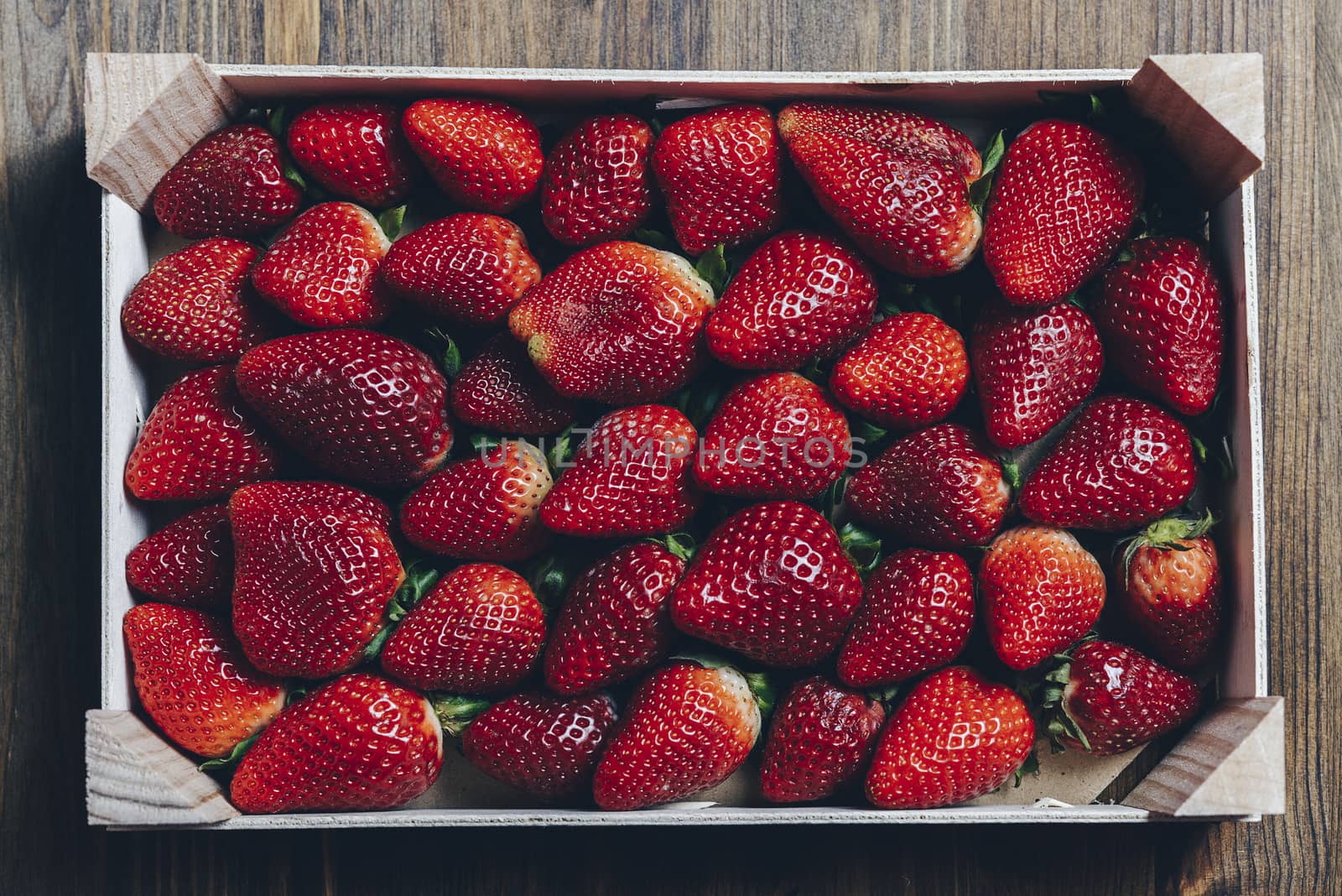 wooden box with strawberries on a wooden table, top view point, healthy sweet food, vitamins and fruity concept .Food frame background, flat lay