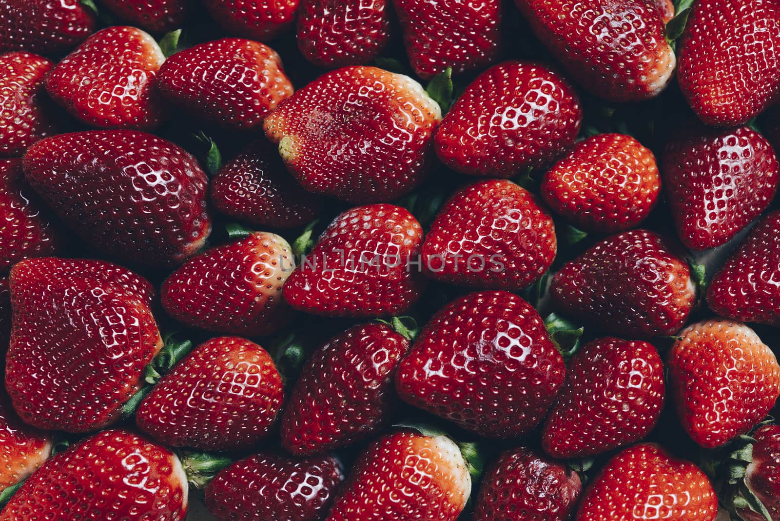 background image of red strawberries seen from above, healthy sweet food, vitamins and fruity concept. Food frame background, flat lay, top view point
