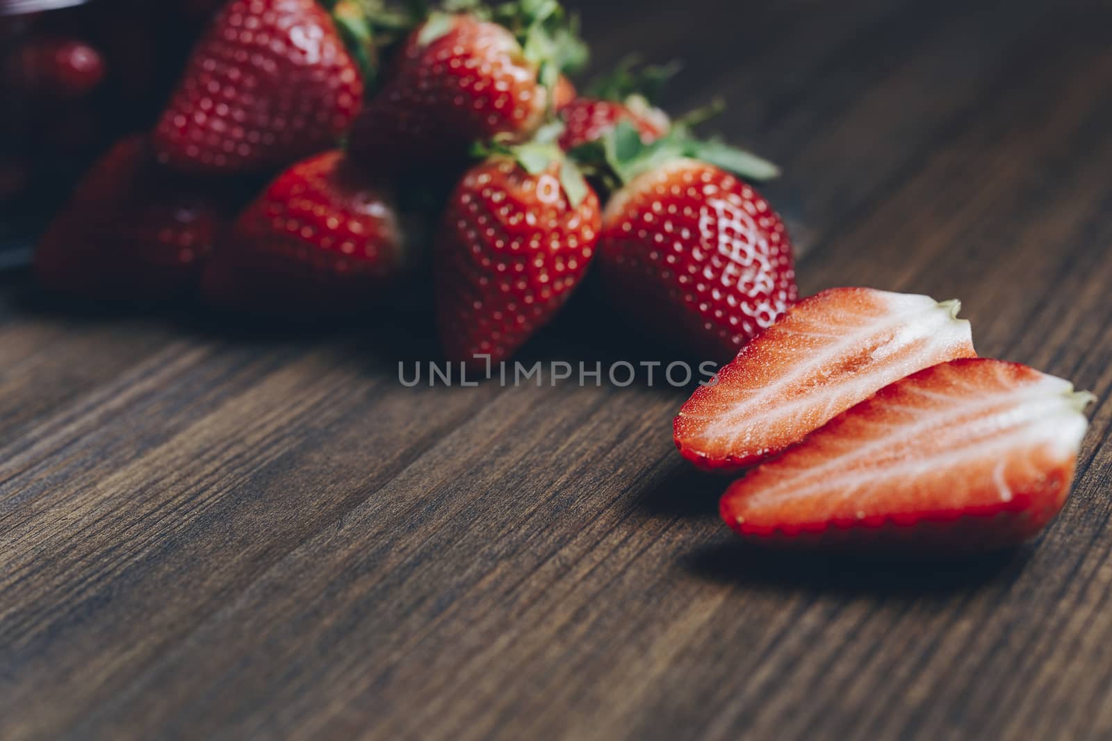 Fresh and juicy strawberries on wooden background in rustic style, healthy sweet food, vitamins and fruity concept. Copy space for text