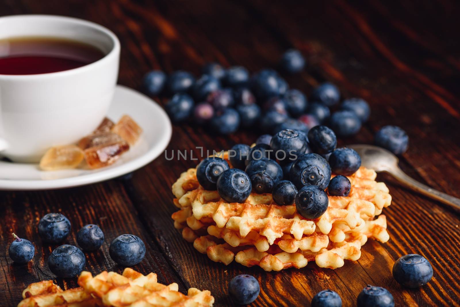 White Cup of Tea with Blueberries and Homemade Waffles for Breakfast.