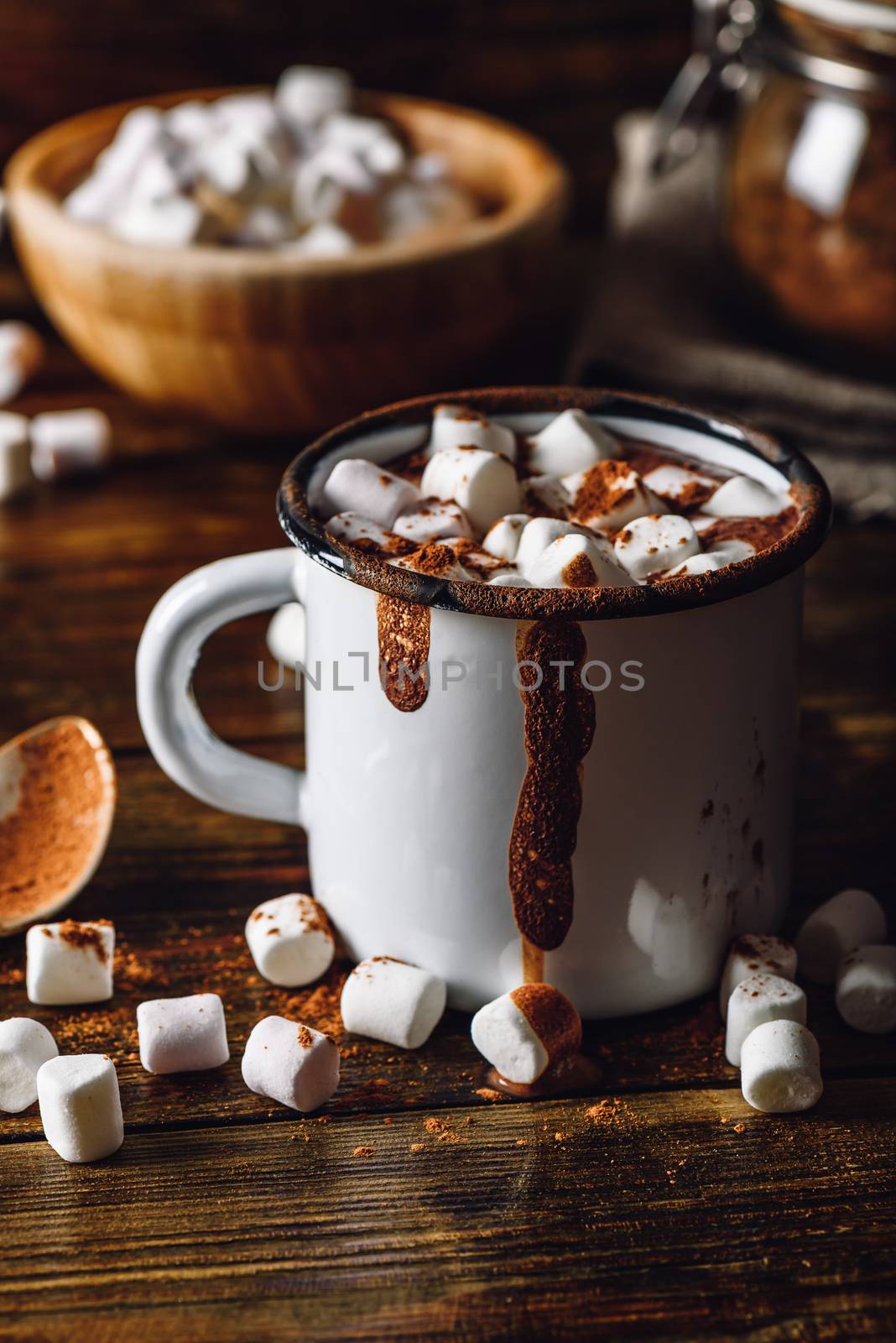 Cocoa Mug with Marshmallows. Jar of Cocoa Powder and Marshmallow Bowl on Backdrop. Vertical Orientation.