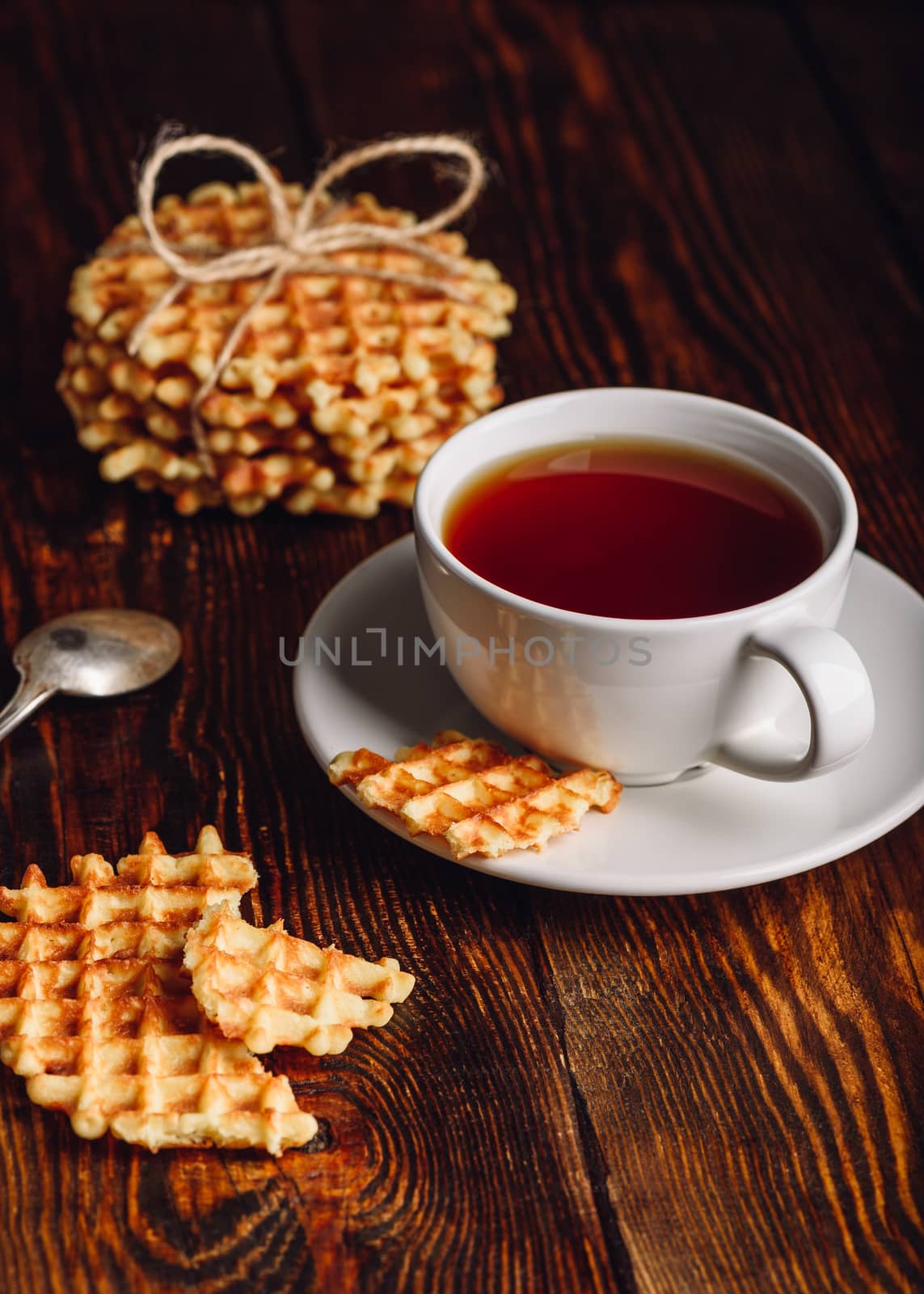 White Cup of Tea and Belgian Waffles for Dessert. Vertical Orientation.