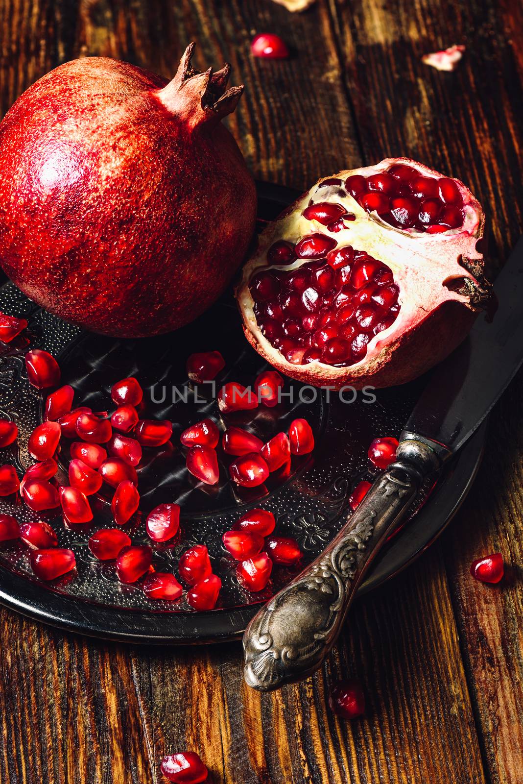 Pomegranates with Seeds and Knife. by Seva_blsv