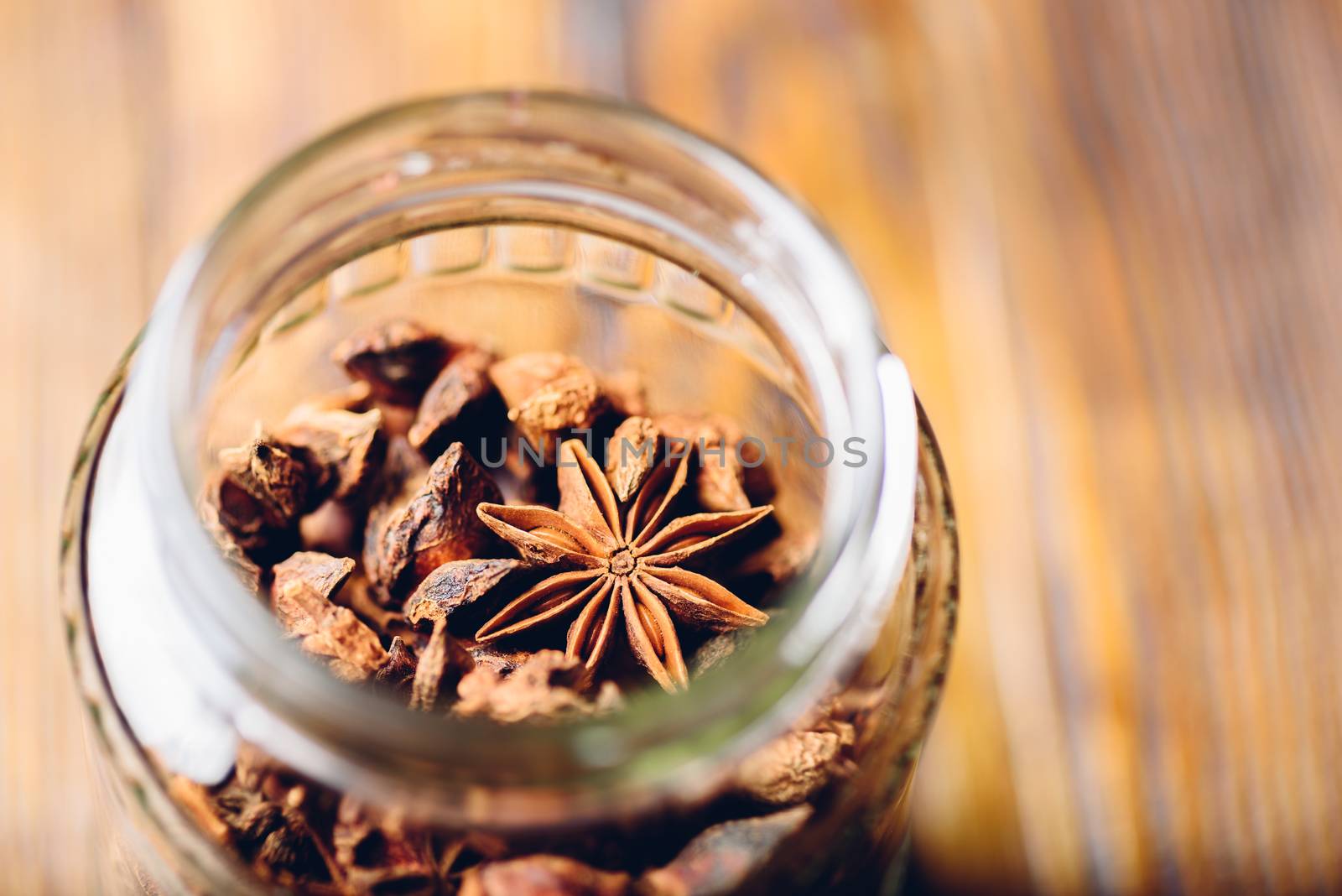 Jar of Star Anise. High Angle View through the Bottleneck.
