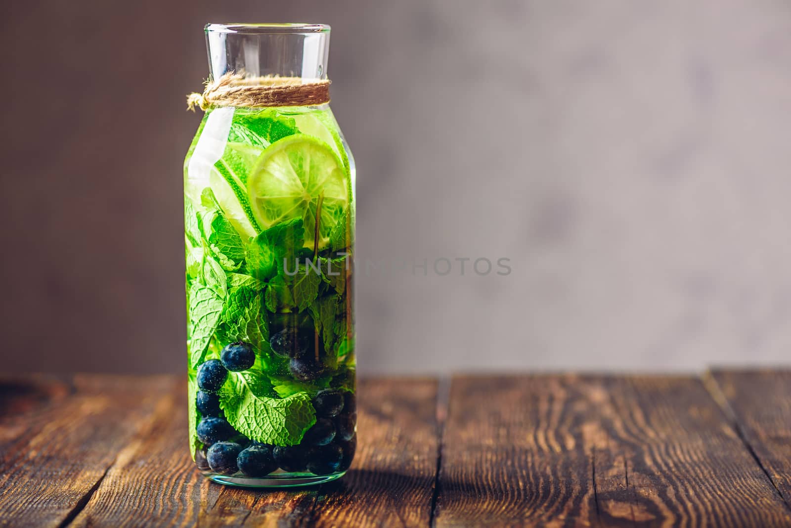 Jug of Water Flavored with Lime, Mint and Blueberry. Copy Space on the Right.