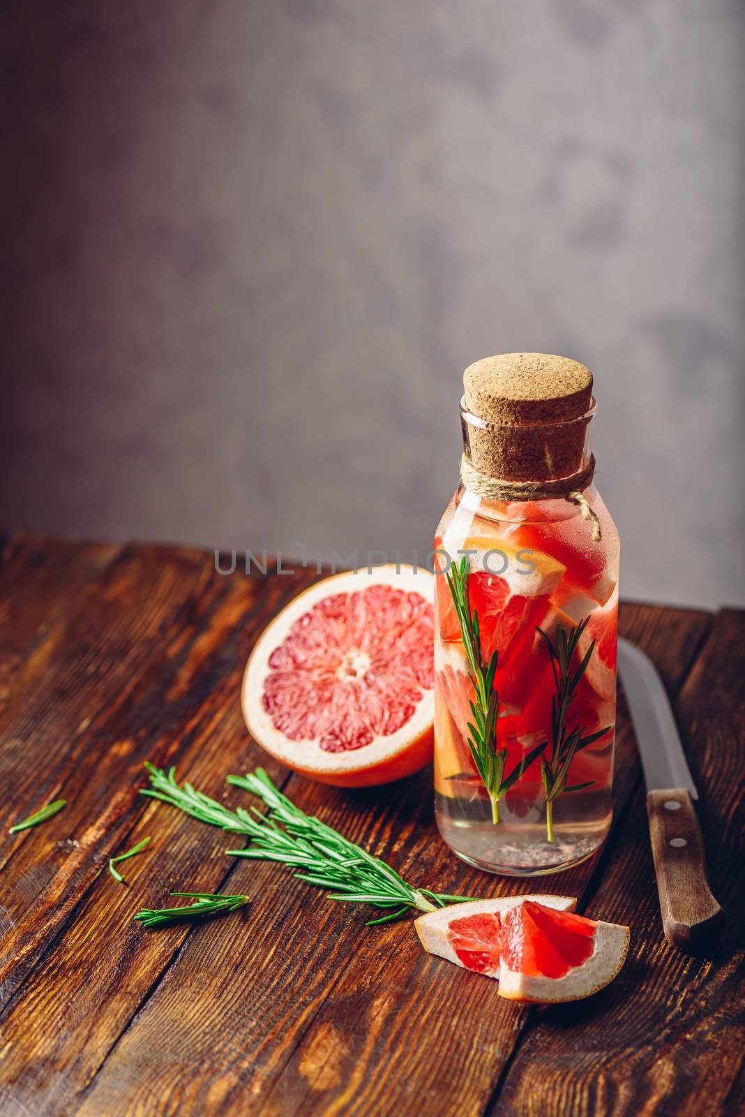 Summer Drink with Sliced Grapefruit and Fresh Rosemary. Vertical Orientation. Copy Space on the Top.