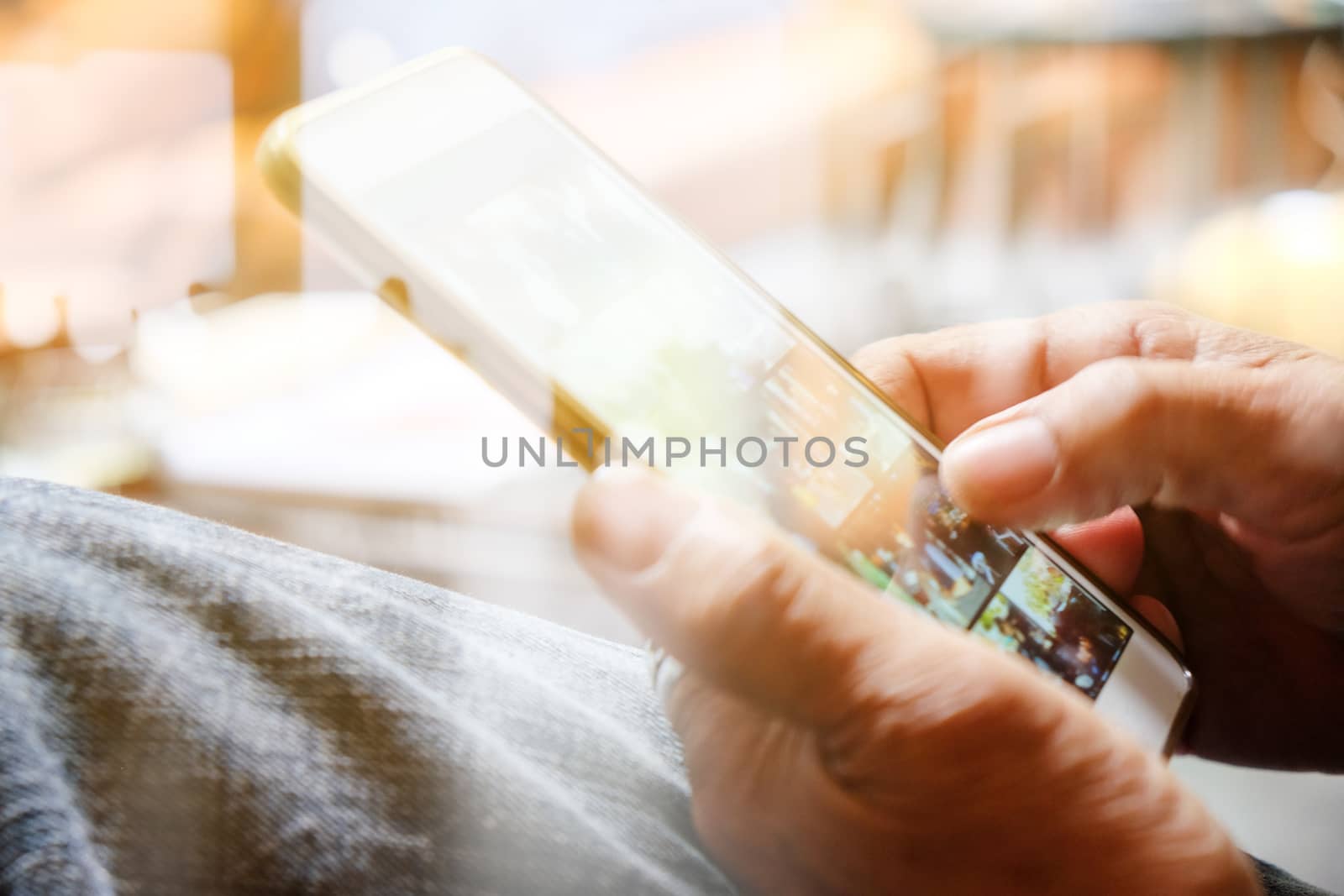Hands with mobile, double exposure