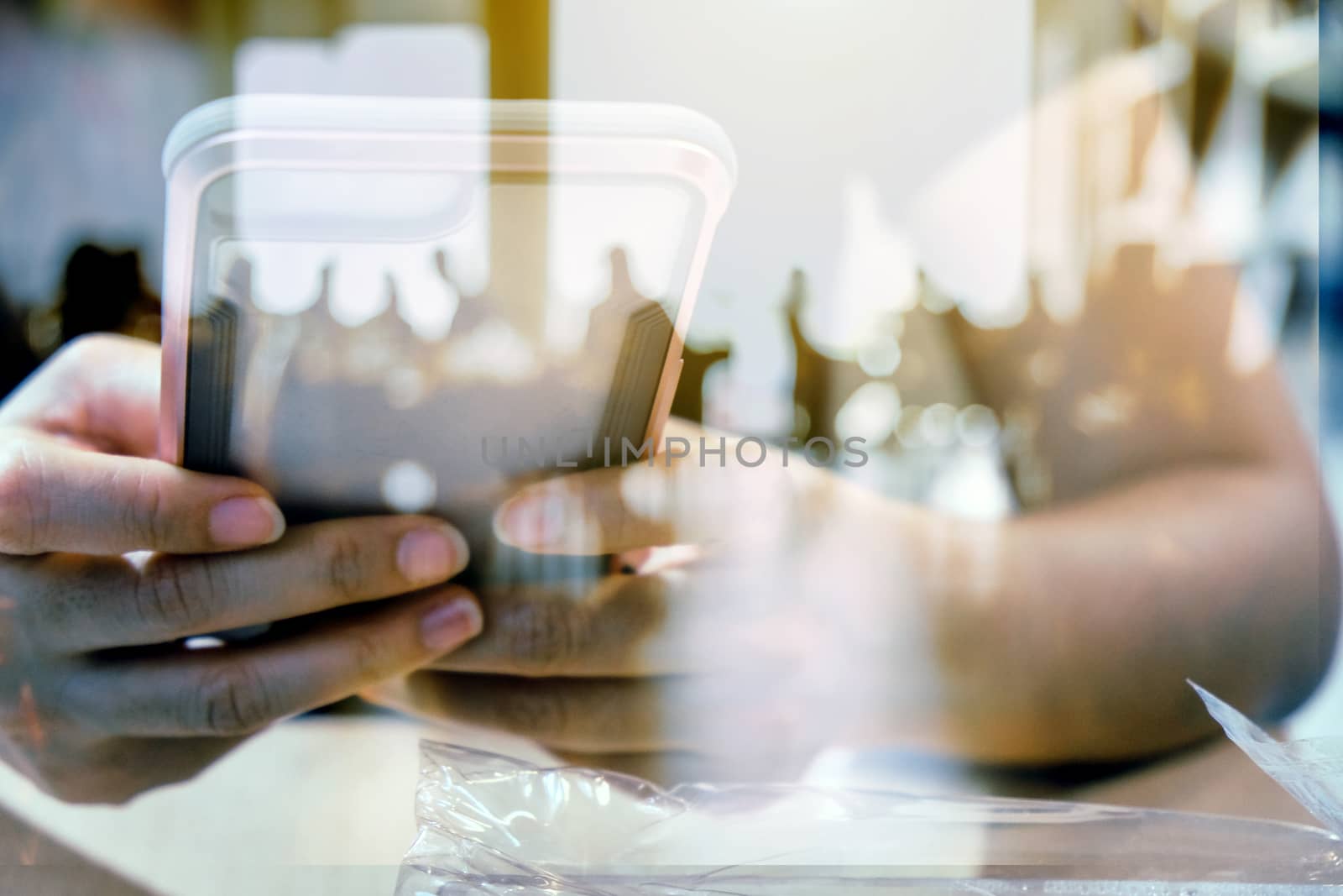 Hands with mobile, double exposure