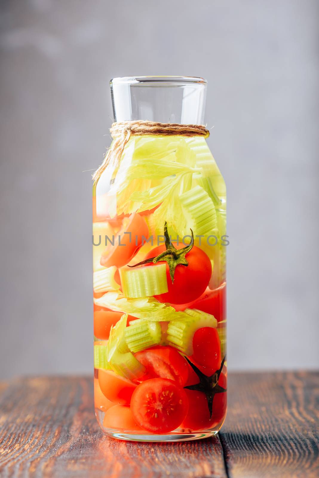 Water Infused with Cherry Tomato and Celery Stems. Vertical Orientation.