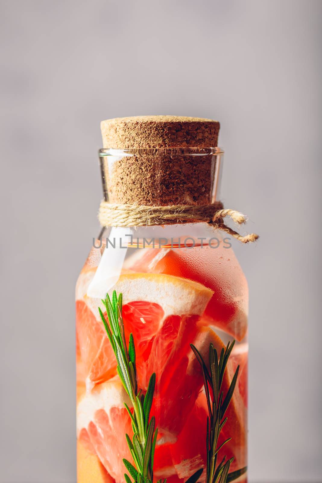 Summer Drink with Sliced Grapefruit and Springs of Rosemary. Vertical Orientation.