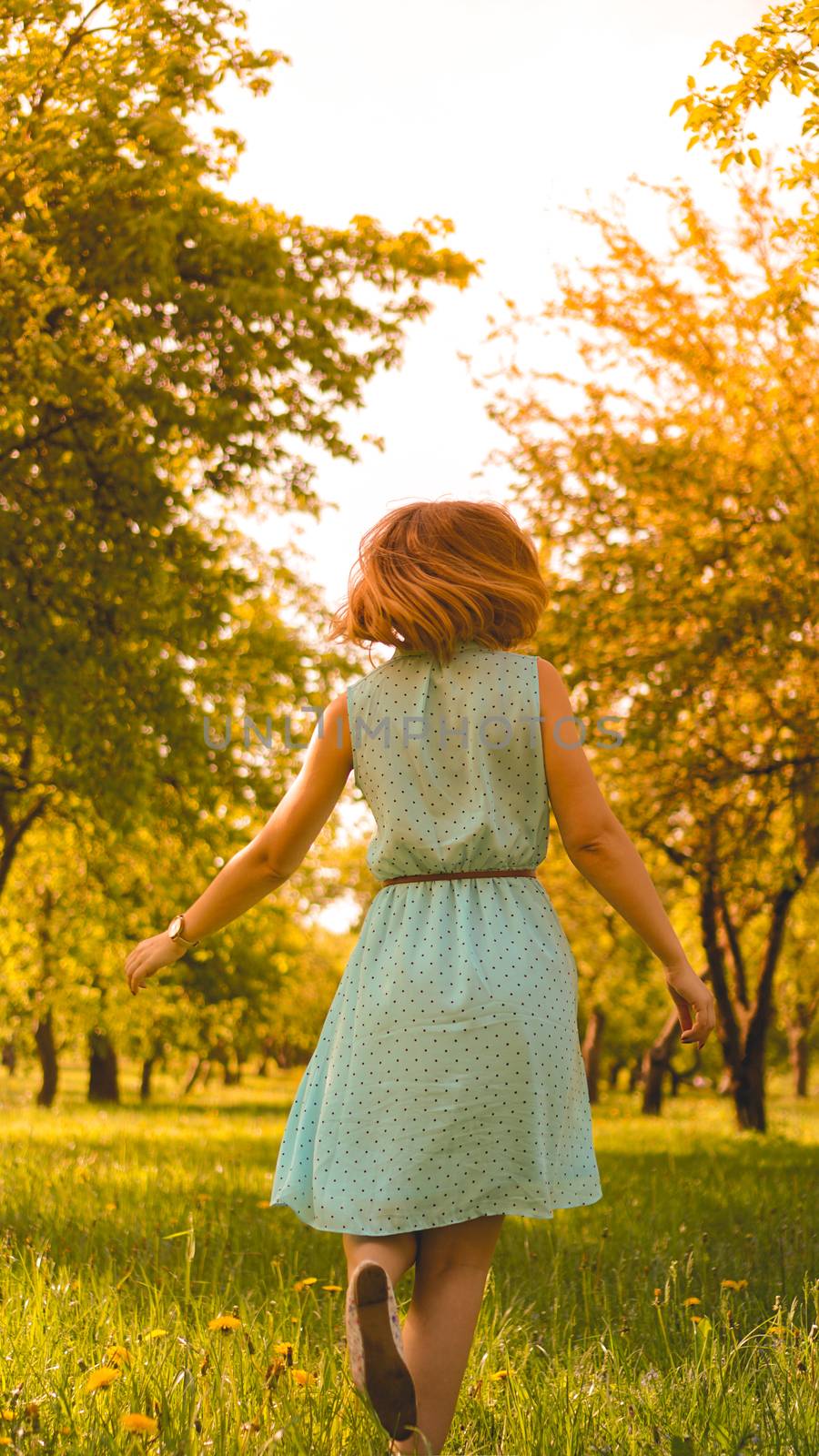 Spring Girl enjoying nature. Beautiful Young Woman Outdoors. Healthy Girl in the Green Park. Sunny day