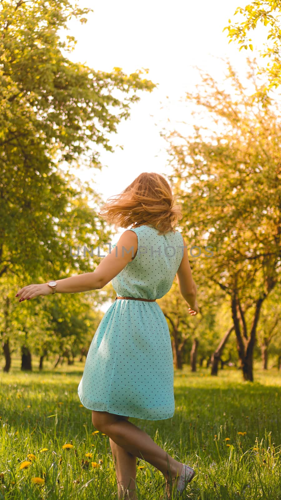 Spring Girl enjoying nature. Beautiful Young Woman Outdoors. Healthy Girl in the Green Park. Sunny day