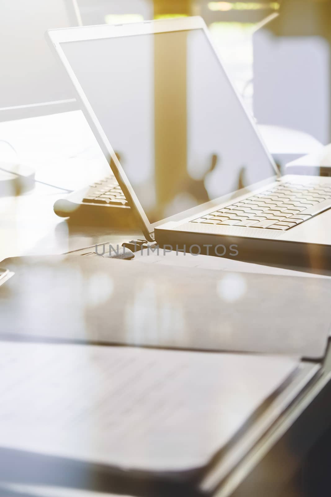 Laptop and papers on desk double exposure