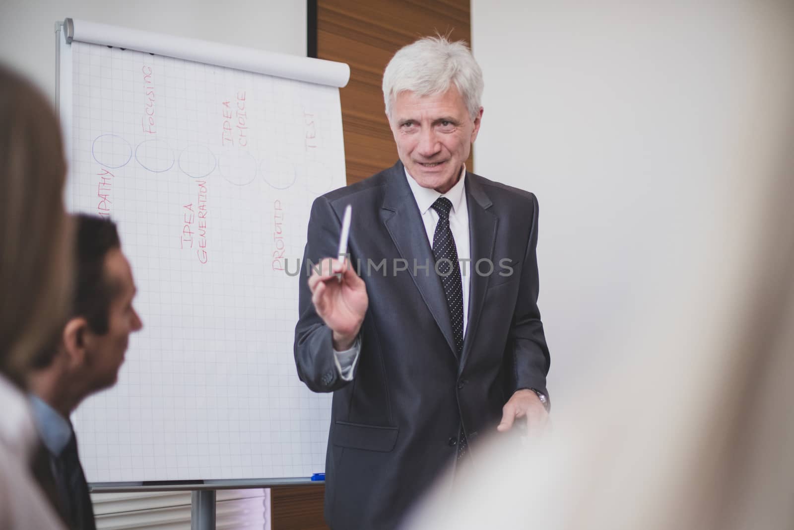 Business man speaking on seminar , whiteboard or flipchart on background