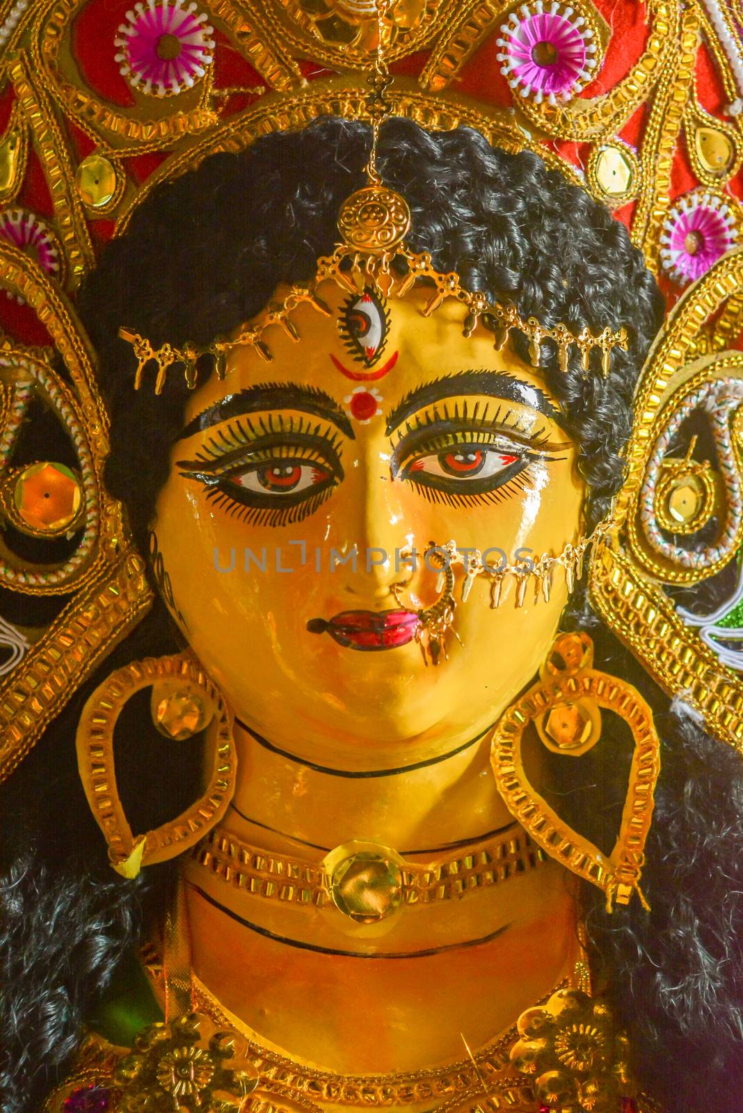 A close up face of Goddess Maa Durga Idol. A symbol of strength and power as per Hinduism. This portrait was taken during Durga Puja celebrations at a potter's studio in Kumartuli in Kolkata. by sudiptabhowmick