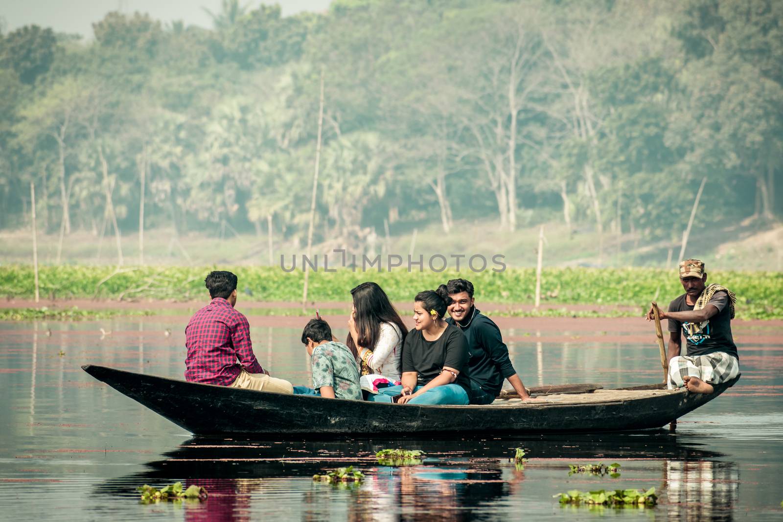 Purbasthali, OXBow Lake, Chupi, Bardhaman, West Bengal, India 1 December 2019 - Holiday people watching and photographing migratory birds in a fishing boat called Nouka during winter months.