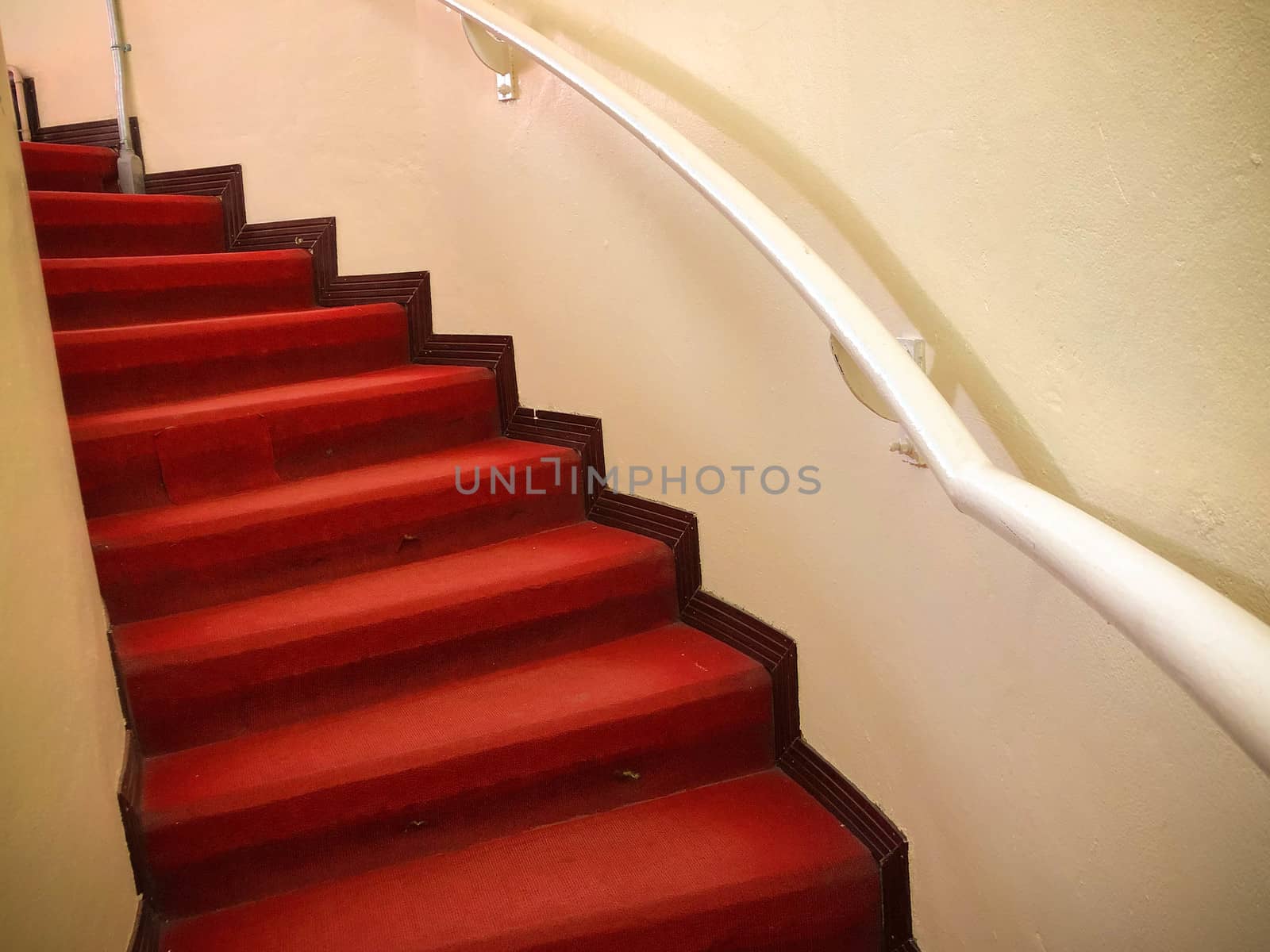 Red carpet on the White stairs in a interior by N_u_T
